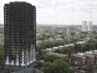 The burnt Grenfell Tower apartment building stands testament to the recent fire in London,