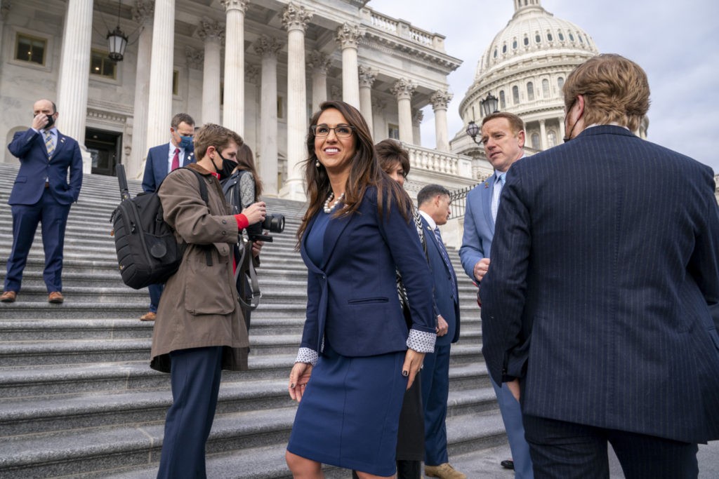 FILE - In this Jan. 4, 2021, file photo, Rep. Lauren Boebert, R-Colo., center, joins other freshman Republican House members for a group photo at the Capitol in Washington. The district's newest representative, Boebert, is an unabashed, social media-savvy loyalist of former President Donald Trump who, like her fellow first-term colleague GOP Rep. Marjorie Taylor Greene of Georgia, is stoking controversy with her far-right views and defiant actions. But unlike Greene, Boebert doesn't hail from an overwhelmingly GOP, safe district. (AP Photo/J. Scott Applewhite, File)