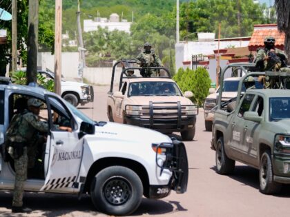 National Guard forces and Army soldiers patrol during an operation in a neighborhood of Cu