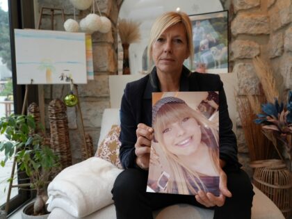 Stephanie Mistre, 51, holds a picture of her daughter, Marie Le Tiec, a teenager who died