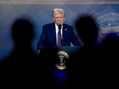 Attendees listen to a virtual speech delivered by U.S. president Donald Trump, at the Annu