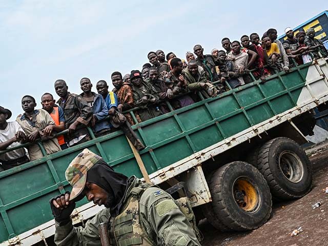 M23 rebels escort government soldiers and police who surrendered to an undisclosed locatio