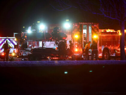 Emergency crews respond to the crash site near the Potomac River after a passenger jet col