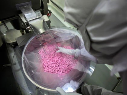 A chemist is seen working in a lab where medicines are being produced at a Cipla manufactu