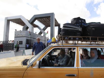 Palestinians wait in a car to cross to Egypt, at the border between the Gaza Strip and Egy