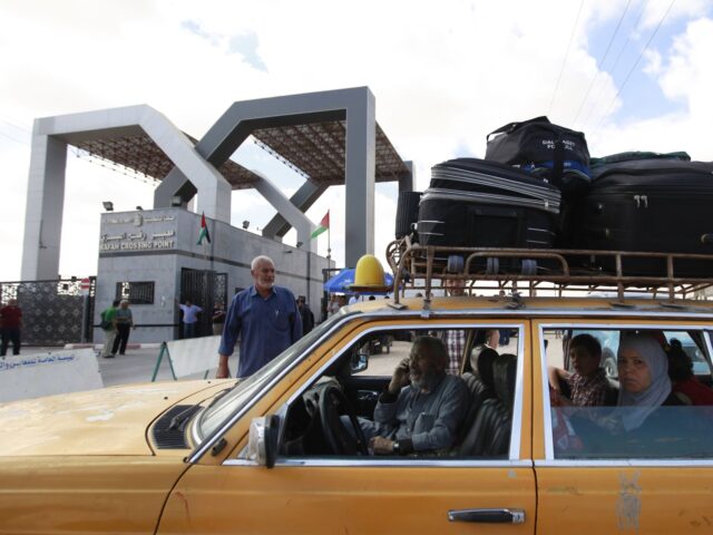 Palestinians wait in a car to cross to Egypt, at the border between the Gaza Strip and Egy