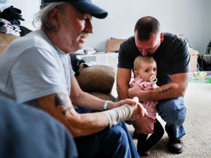 Tom Wolikow, right, holds his daughter Annabella alongside his father John, left, at their