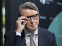 Peter Mandelson, founder and chairman of Global Counsel LLP, adjusts his glasses during a