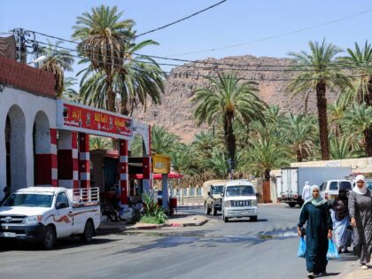 People walk on a roadside in the oasis town of Djanet in southeastern Algeria on July 27,