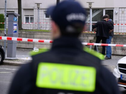 11 March 2024, Berlin: Police officers stand around the suspected crime scene in Zimmerstr