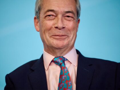 Britain's far right party leader Reform UK Nigel Farage reacts as he attends a Refor