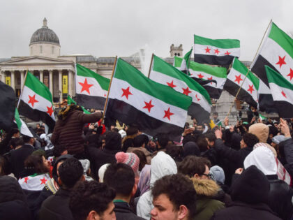 LONDON, UNITED KINGDOM - 2024/12/08: Members of the Syrian community and supporters holdin