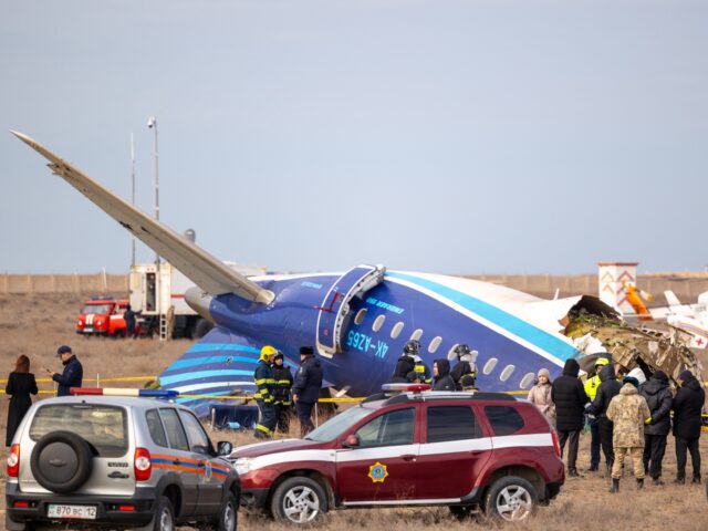 Emergency specialists work at the crash site of an Azerbaijan Airlines passenger jet near