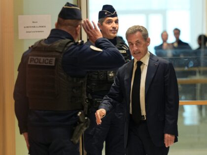 Former French president Nicolas Sarkozy (R) arrives at Paris courthouse in Paris, on Janua