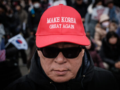 A supporter of detained and impeached South Korean President Yoon Suk Yeol wears a cap cop