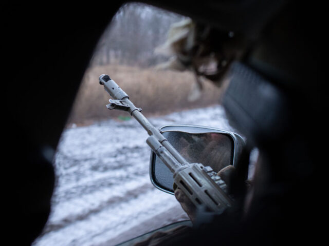 CHASIV YAR, UKRAINE - JANUARY 17: 'Dean' puts hits automatic gun at the car wind