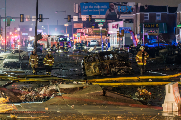 The crash of a medical air ambulance caused a massive crater where it impacted a Philadelphia street. (Thomas Hengge/Anadolu via Getty Images)