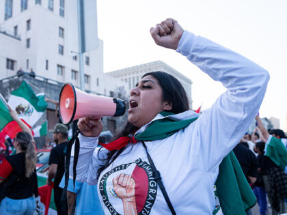 Protestors join a rally and march in support of immigrants in response to the Trump admini