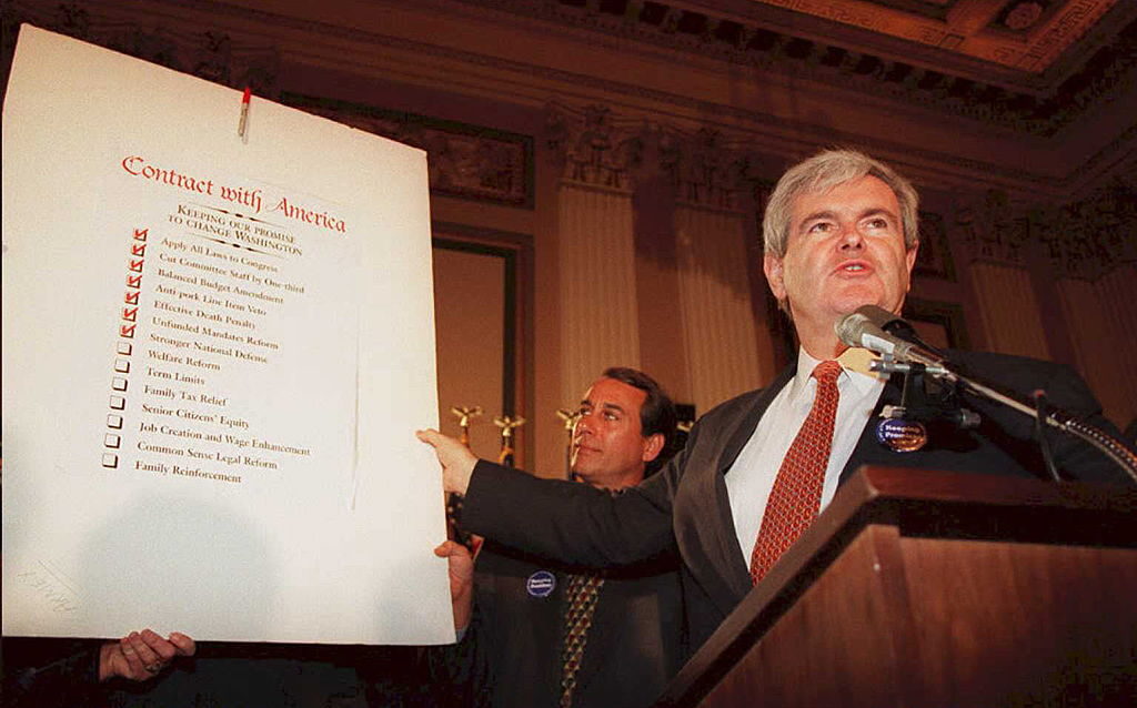 WASHINGTON, DC - FEBRUARY 22: Speaker of the US House of Representatives Newt Gingrich(R-GA), holds up a copy of the Republican party's "Contract With America" during a rally to celebrate the first 50 days of the Republican majority in Congress 22 February. Gigngrich is also preparing a plan to outline the House agenda for the rest of the year, which will attempt to put substance behind the Republican call for a balanced budget. (COLOR KEY: Tie is red.) AFP PHOTO (Photo credit should read JOSHUA ROBERTS/AFP via Getty Images)