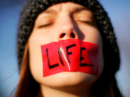 Pro-life activist Lynn Jackson, with the group Bound for Life, protests in front of the U.