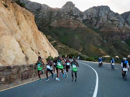 A group of the leading runners run on Chapman's Peak as they compete in the Two Oceans ult