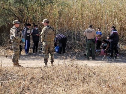 Texas National Guardsmen assist Border Patrol with a migrant family who illegally crossed