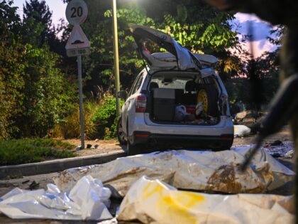 BE'ERI, ISRAEL - OCTOBER 11: Bodies of Hamas militants in body bags are left on the road i