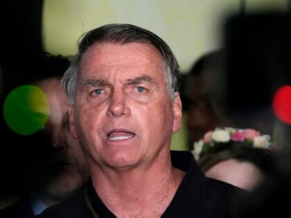 Former President Jair Bolsonaro speaks to the press after being formally charged by the fe