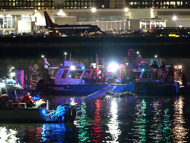 ARLINGTON, VIRGINIA - JANUARY 30: Emergency units respond after a passenger aircraft colli