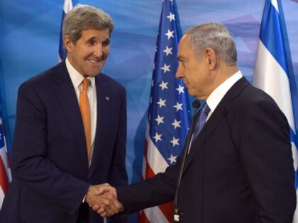 Israel's Prime Minister Benjamin Netanyahu, right, shakes hands with US Secretary of