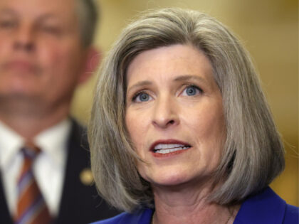 U.S. Sen. Joni Ernst (R-IA) speaks as Sen. Steven Daines (R-MT) listens during a news brie