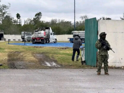 Mexican Navy infantryman guards the entrance to a a migrant camp under construction in Mat