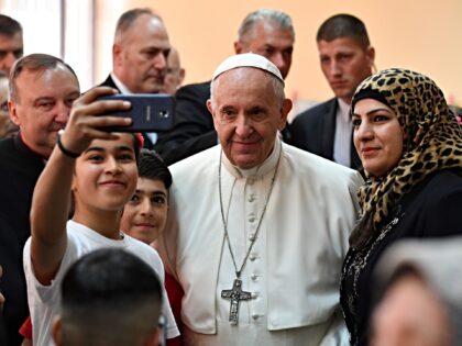 Pope Francis poses for a selfie with young refugees during a visit to the Vrazhdebna refug