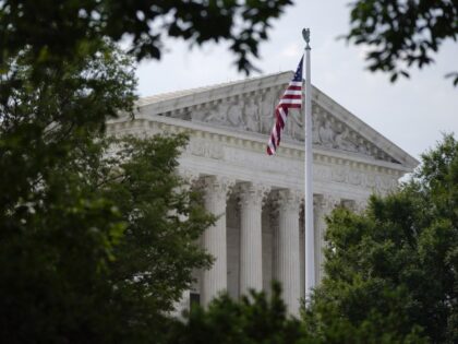 An American flag waves in front of the U.S. Supreme Court building, Monday, June 27, 2022,