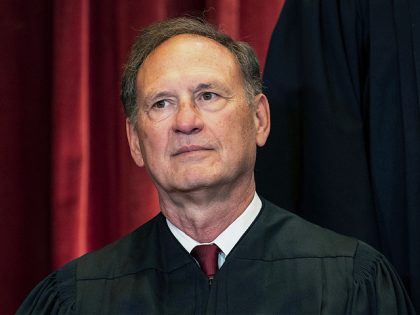 Associate Justice Samuel Alito sits during a group photo at the Supreme Court in Washingto