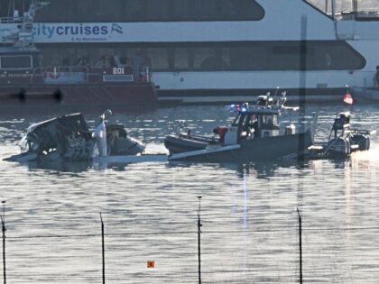 ARLINGTON, VIRGINIA - JANUARY 30: Emergency response units search the crash site of the A