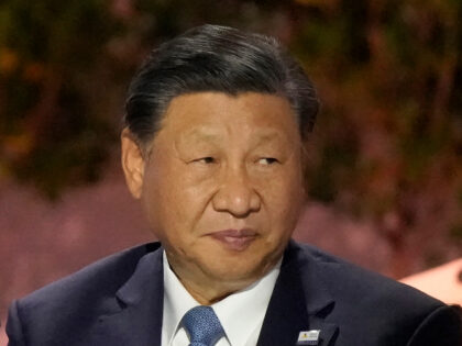 Chinese President Xi Jinping sits next to other world leaders during the Asia-Pacific Econ