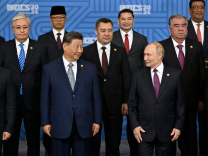 Russian President Vladimir Putin, right, and other participants pose for a family photo pr